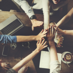 Gruppo di professionisti riuniti intorno a tavolo in lavoro collaborativo pro bono